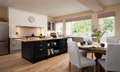 Wark Farmhouse - the spacious kitchen with large island and dining table seating up to eight guests