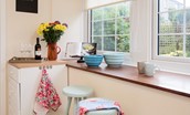Fisherman's Cottage - breakfast bar area with two stools and garden views