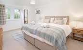 Fisherman's Cottage - bedroom one on the ground floor with zip and link beds, side tables and chest of drawers