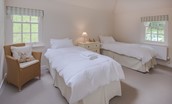 Gardener's Cottage - bedroom three with zip and link beds, chest of drawers, chair and dual aspect views