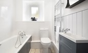 Campsie Cottage - a family bathroom, with a bath and shower over, is located on the ground floor of the cottage