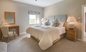 Granary - bedroom one on upper floor with zip and link beds, dressing table and side tables