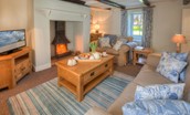 Grove House - sitting room with cosy log burner, two sofas and TV (updated photography coming soon)