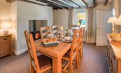 Grove House - dining room with dining table, seating for six guests and wood burning stove