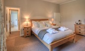 Grove House - bedroom one with king size bed and en suite bathroom