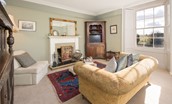 Halliburton - sitting room with sofa, armchair, decorative fireplace and TV