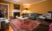 Church House - a spacious fire-warmed sitting room with ample seating and a selection of books