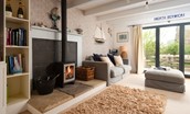 Nook End - large bi-fold doors creates a bright space, while the log fire will keep you cosy