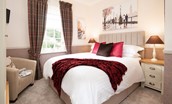 Bank View - bedroom one with double bed, quality linen and single armchair