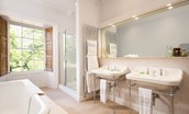 Honeystone House - spacious Jack and Jill en suite of bedroom three with large bath tub, two sinks and separate shower