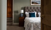 Cairnbank House - super king size bed in bedroom one with steps leading to a separate dressing room
