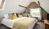 Caste View, Bamburgh - bedroom seven on the second floor with coombed ceiling and characterful original stonework