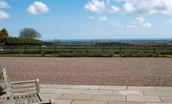 Bracken Lodge - bench seating with views across pasture to the coast beyond