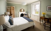 Cairnbank House - bedroom two with decorative fireplace and dressing table enjoys front facing views