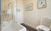 The Fairway - family bathroom with bath and shower over, WC, basin, and heated towel rail