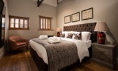 Coach House - bedroom four with zip and link beds, side tables and chair
