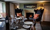 The Boathouse - the stylish chairs by the open fire in the dining room