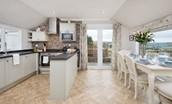 Pennine Way Cottage - kitchen & dining area with doors to terrace
