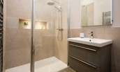 The Steading at West Lyham - bedroom four en suite bathroom with large walk-in shower, WC and basin