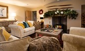 Goose Cottage at Christmas - sitting room with a large fresh foliage garland, mounted upon the timber mantel