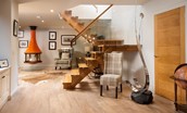 Coledale Stables - open-plan sitting room with staircase leading to the first floor