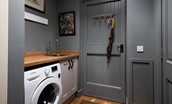 Rowchester West Lodge - utility room with washing machine and hooks for hanging outdoor kit