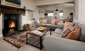Farm Cottage - the cosy sitting room area with sofas set around the fireplace and wood burner