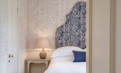 Hamilton House - bedroom two with patterned headboard and blue tones