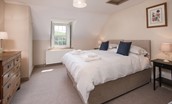 College Cottage - bedroom three with zip and link bed, separate single bed, side tables and chest of drawers