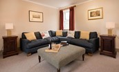 Bowmont Cottage - sitting room with large corner sofa
