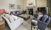 Crookhouse Mill - open-plan sitting room with ample seating, wood burning stove and TV