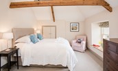 Crookhouse Mill - bedroom three on the first floor with king size bed, armchair, chest of drawers and en suite bathroom
