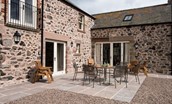 Crookhouse Mill - outside patio area with garden furniture and French doors leading into the kitchen and living area