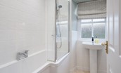 Curlew Cottage - family bathroom with bath and shower over, WC and basin