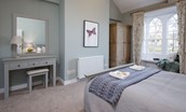 Curlew Cottage - bedroom one with king size bed, dressing table and wardrobe