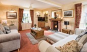 Dryburgh Farmhouse - lounge with two large sofas, cosy wood burner and TV