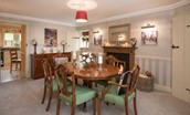 Dryburgh Stirling One - dining room with dining table seating six guests, sideboard and open fire