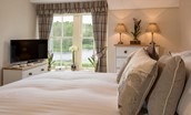Dryburgh Stirling One - bedroom two with king size bed, chest of drawers, TV and views of the River Tweed
