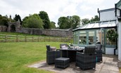 Dryburgh Stirling Two - conservatory and rear garden with rattan garden furniture