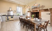 East House - spacious kitchen with large inglenook fireplace, wood burning stove, large Rangemaster cooker and dining table with seating for ten guests