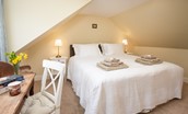 Gardener's Cottage, Elliston - bedroom one with zip and link beds, dressing table and side tables