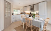Dipper Cottage - kitchen with dining table seating for four guests and entrance door