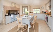 Dipper cottage - kitchen with Rayburn, dining table seating four guests and blue colour scheme
