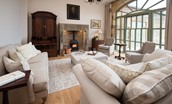 Beeswing - sitting room with inglenook fireplace with wood burning stove and large arched window