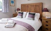 Crosslea - bedroom one with double bed and side tables
