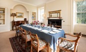 East House - dining room with seating for ten guests and wood burning stove