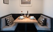 Calder Cottage - monochrome dining area with bench seating