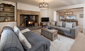 Bowls Cottage - open-plan sitting room with large inglenook fireplace and wood burning stove leading into dining area