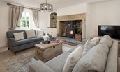 Bowls Cottage - open-plan sitting room with inglenook fireplace and wood burning stove