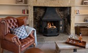 Bowls Cottage - sitting room two with leather armchair, large fireplace and gas burner